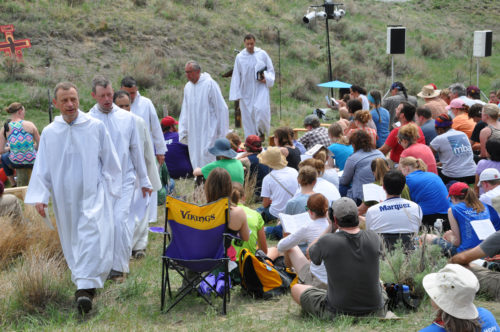 Brother Alois, the abbot of the Taizé Community in France, leads worshippers out of the natural amphitheater worship spaces after Morning Prayer on May 25, which began the first full day of the May 24-27 Taizé “pilgrimage of trust on earth” held on the Pine Ridge Indian Reservation in southwestern South Dakota. Photo: Mary Frances Schjonberg/Episcopal News Service