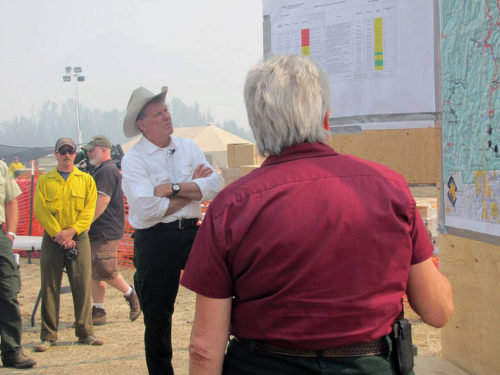 Idaho Governor Clement Leroy "Butch" Otter gets a Beaver Creek Fire briefing from Incident Commander Beth Lund (back to camera). The Beaver Creek Fire is the #1 priority fire in the United States. Photo: Great Basin National Incident Management Team #1