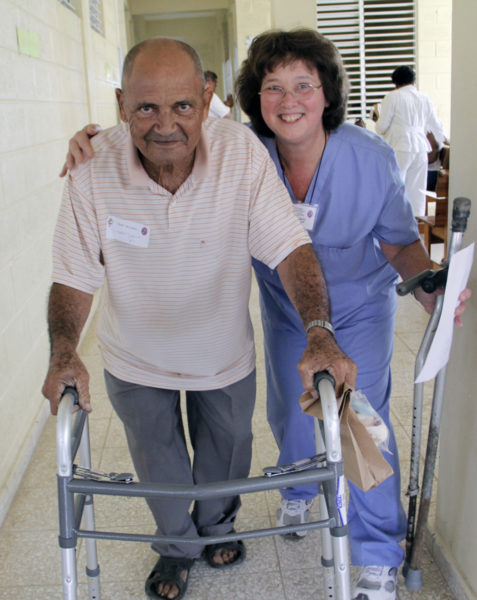 Anne Bena, a physical therapist, fits a patient with a walker. Before receiving the walker, the patient, who Bena has known for four years, used two crutches to get around. Photo: Lynette Wilson/Episcopal News Service