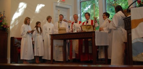 Presiding Bishop Katharine Jefferts Schori, presides at Holy Eucharist at the altar of Holy Cross Faith Memorial Episcopal Church, Pawley's Island, South Carolina, with clergy and acolytes from the Episcopal Church in South Carolina. Among the altar party is Bishop Provisional Charles G. vonRosenberg to Jefferts Schori’s right. Photo: Holly Behre/The Episcopal Church in South Carolina