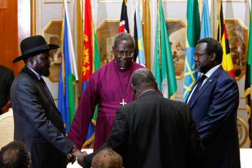 South Sudan's rebel leader Riek Machar (R) and South Sudan's President Salva Kiir (L) hold Episcopal Archbishop Daniel Deng Bul's hands as they pray before signing a peace agreement in Addis Ababa May 9. Photo: Goran Tomasevic/Reuters