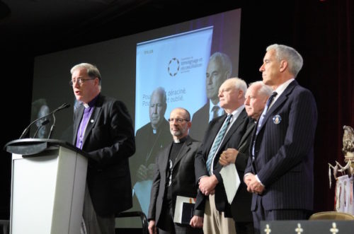 Archbishop Fred Hiltz reads the ecumenical response while (L-R) Fr. Peter Bisson, the Rev. Stephen Farris, Archbishop Gérard Pettipas and the Rt. Rev. Gary Paterson look on. Photo: Art Babych