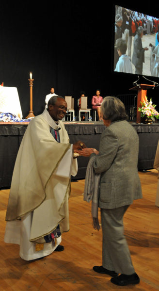 Presiding Bishop-elect Michael B. Curry distributes communion during the Oct. 31 Vigil Celebration offered by the Union of Black Episcopalians at the D.C. Armory on the eve of his installation as the 27th presiding bishop of The Episcopal Church and its primate. Photo: Mary Frances Schjonberg/Episcopal News Service 
