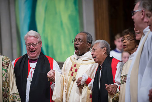 Presiding Bishop Michael B. Curry, center, sings with retired Massachusetts Bishop Suffragan Barbara Harris, the first female bishop in the Anglican Communion; Kansas Bishop Dean Wolfe, a vice president of the House of Deputies; and others during Curry's Nov. 1 installation service at Washington National Cathedral. Photo: Donovan Marks (c) 2015 Washington National Cathedral
